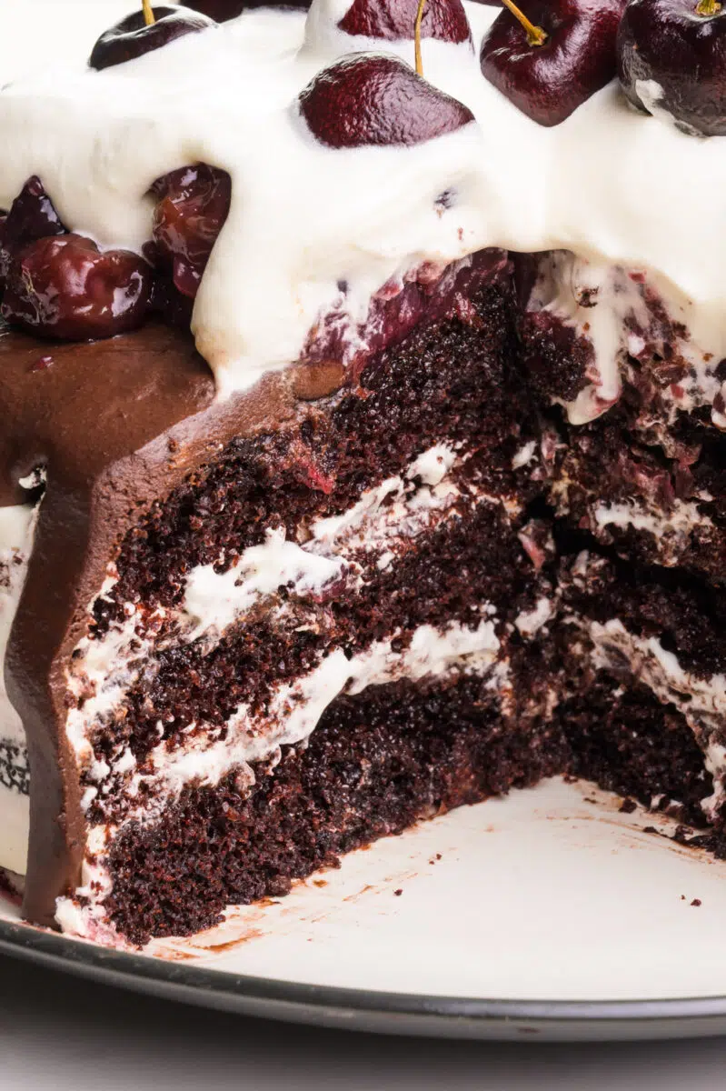 Looking in on a black forest cake that has a slice cut out, showing the different layers.