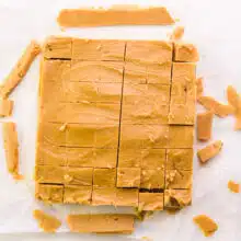 Peanut butter fudge has been removed from a pan and cut into squares.