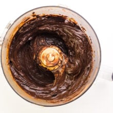 Looking down into a food processor with thick, chocolate mixture in it.