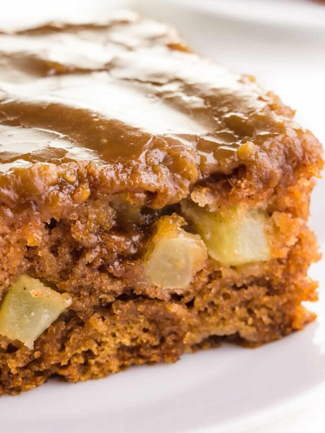 A close-up of egg free apple cake, showing bits of apple in the cake.