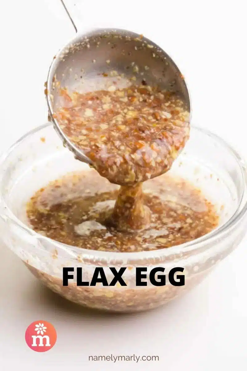 A spoon holds brown liquid hovering over a bowl. The text reads Flax Egg.