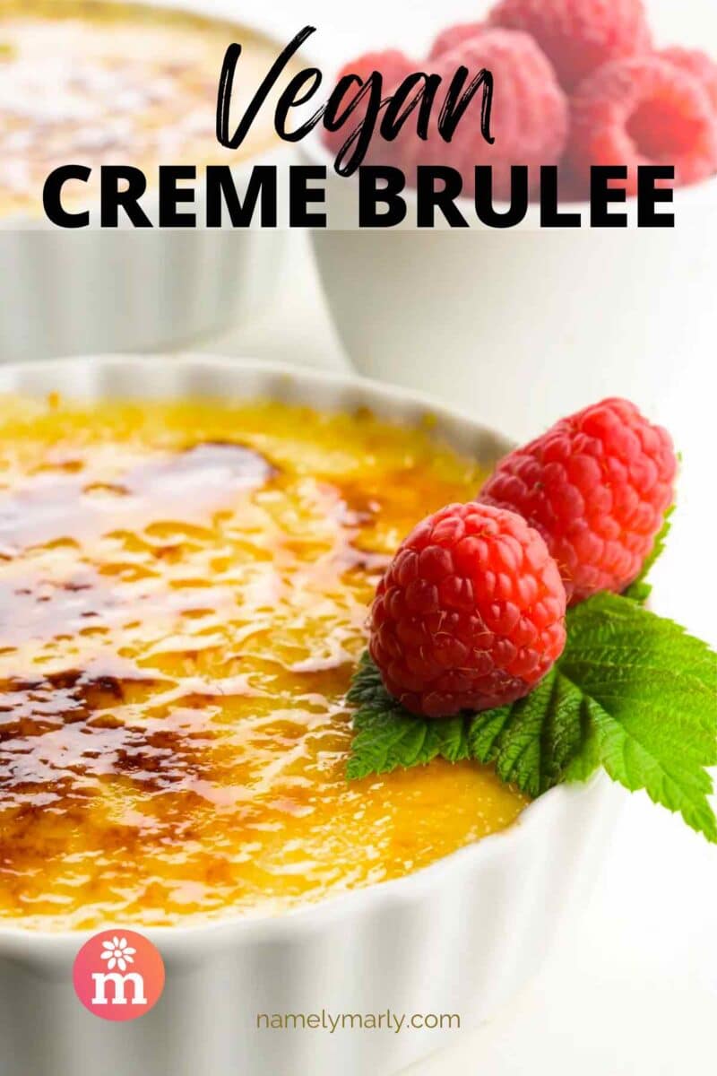 A custard with fresh raspberries sits in front of more raspberries. The text reads Vegan Creme Brulee.