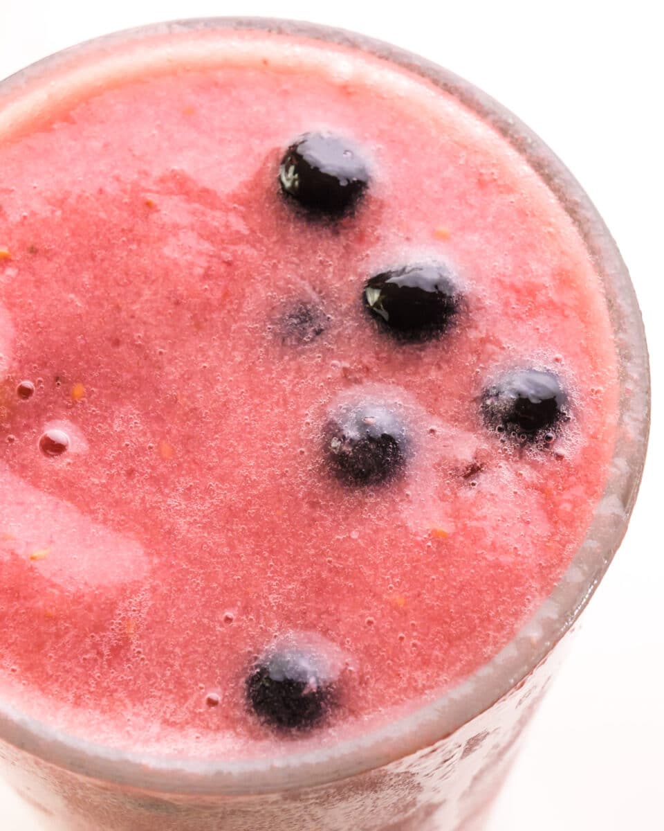 Looking down at a berry smoothie with boba pearls on top.