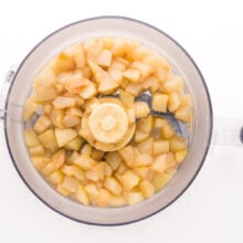 Cooked chopped pears are in a food processor bowl, waiting to be pureed.