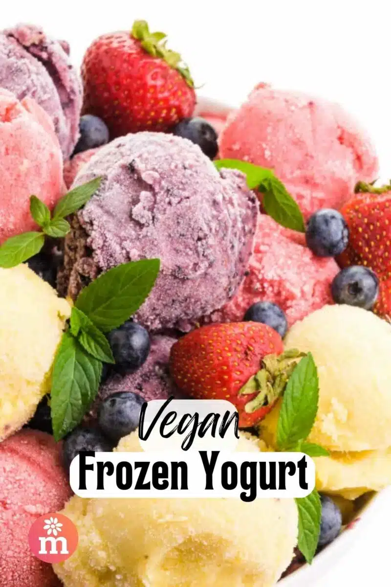 Looking down on a plate of frozen fruit yogurt balls on a plate with fruit. The text reads, Vegan Frozen Yogurt.