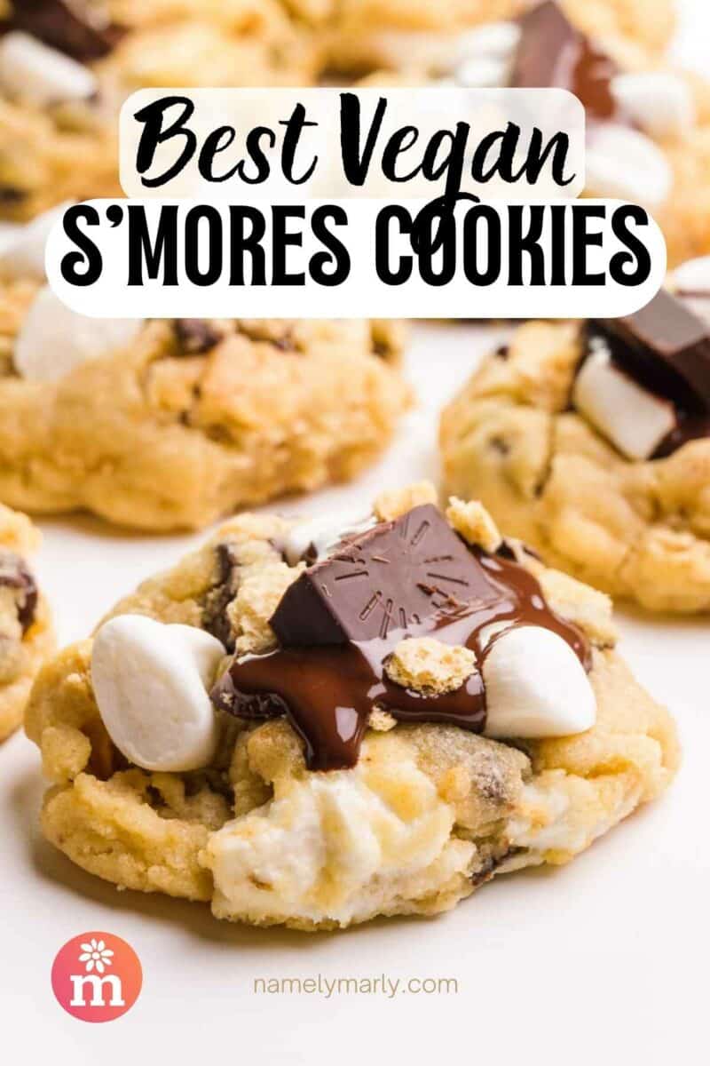 A cookie with melted chocolate and marshmallows sits in front of other cookies.  The article reads, Best Vegan S'mores Cookies.