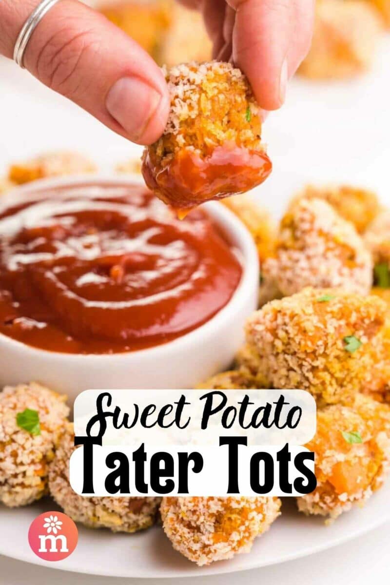 A hand holds a tater tot dipped in ketchup. The text reads, Sweet Potato Tater Tots.