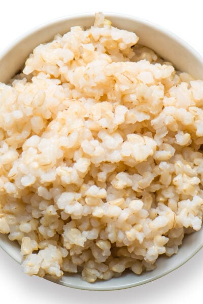 Looking down on a bowl of cooked brown rice.