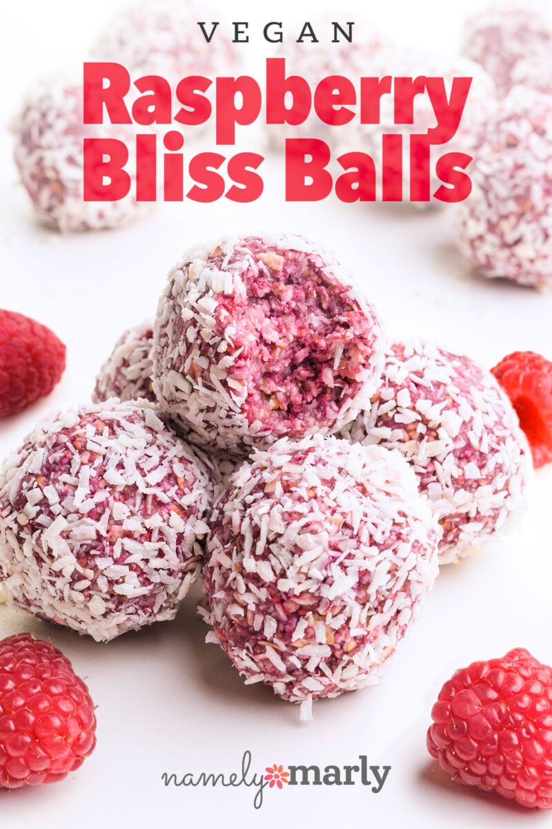 A stack of pink energy balls shows the top one with a bite taken out. The text reads, vegan Raspberry Bliss Balls.