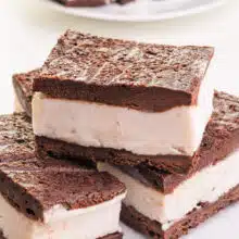 A stack of vegan ice cream sandwiches sit on a plate.