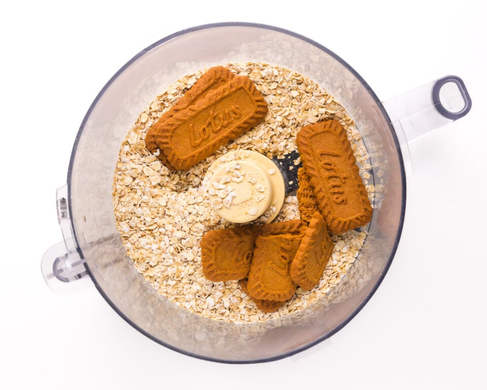Looking down on a food processor bowl with oats and Biscoff cookies.