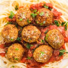 Looking down on a plate of pasta with chickpea meatballs and marinara sauce.