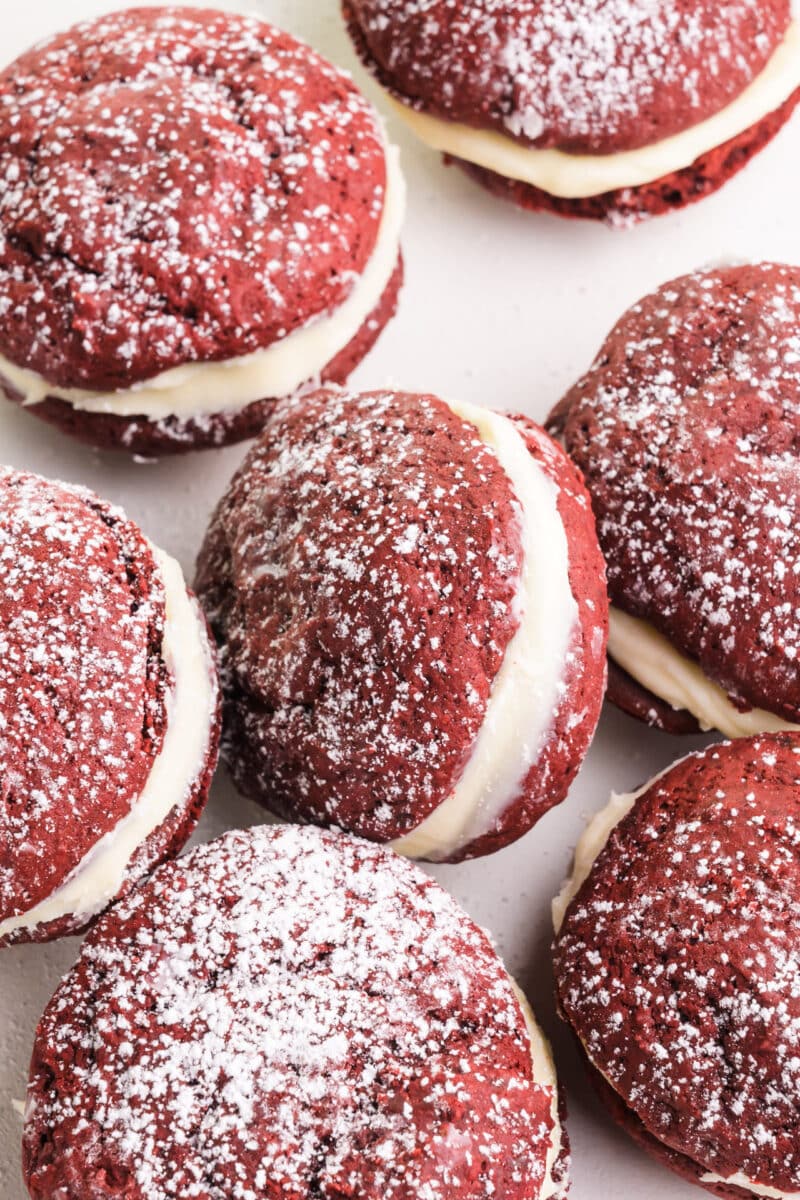Looking down on several red velvet whoopie pies with one of them titled against the others.