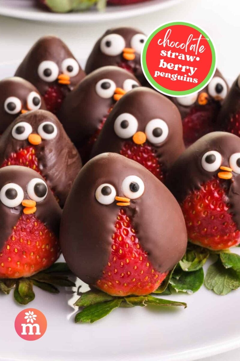 A bunch of chocolate-covered strawberries with candy eyes sits on a plate. The text reads, Chocolate Strawberry Penguins.