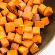 Cooked sweet potato cubes are in a skillet.