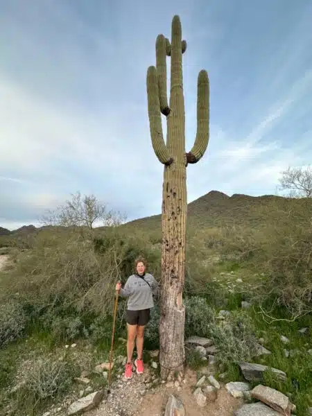 Marly next to a Saguaro at the McDowell Sonoran Preserve park.
