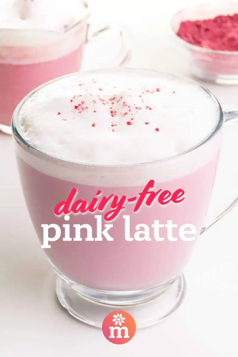 Two mugs of pink latte beside a bowl of pink matcha powder. Text on the image reads: Dairy-Free Pink Latte.