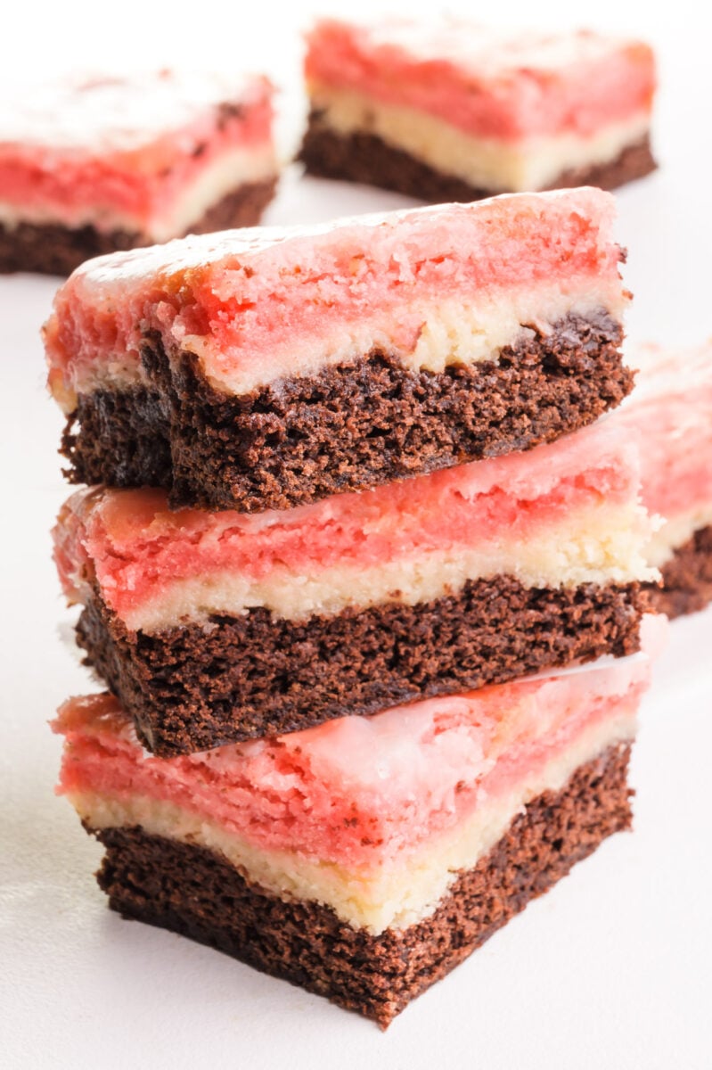 A stack of 3 Neapolitan Bar sits in front of more bars in the background.