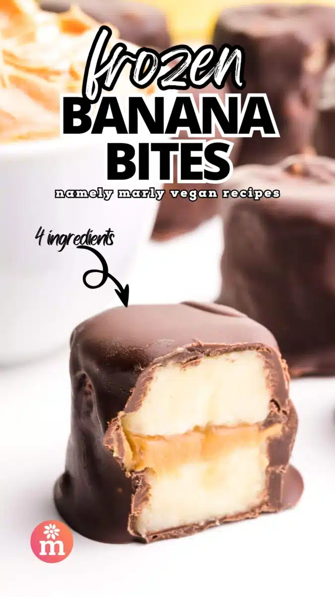 A chocolate banana treat is cut in half and sits on a counter with a bowl of peanut butter and more treats. An arrow points to the text with the text, 4 ingredients. The rest of the text reads, Frozen Banana Bites, Namely Marly Vegan Recipes.
