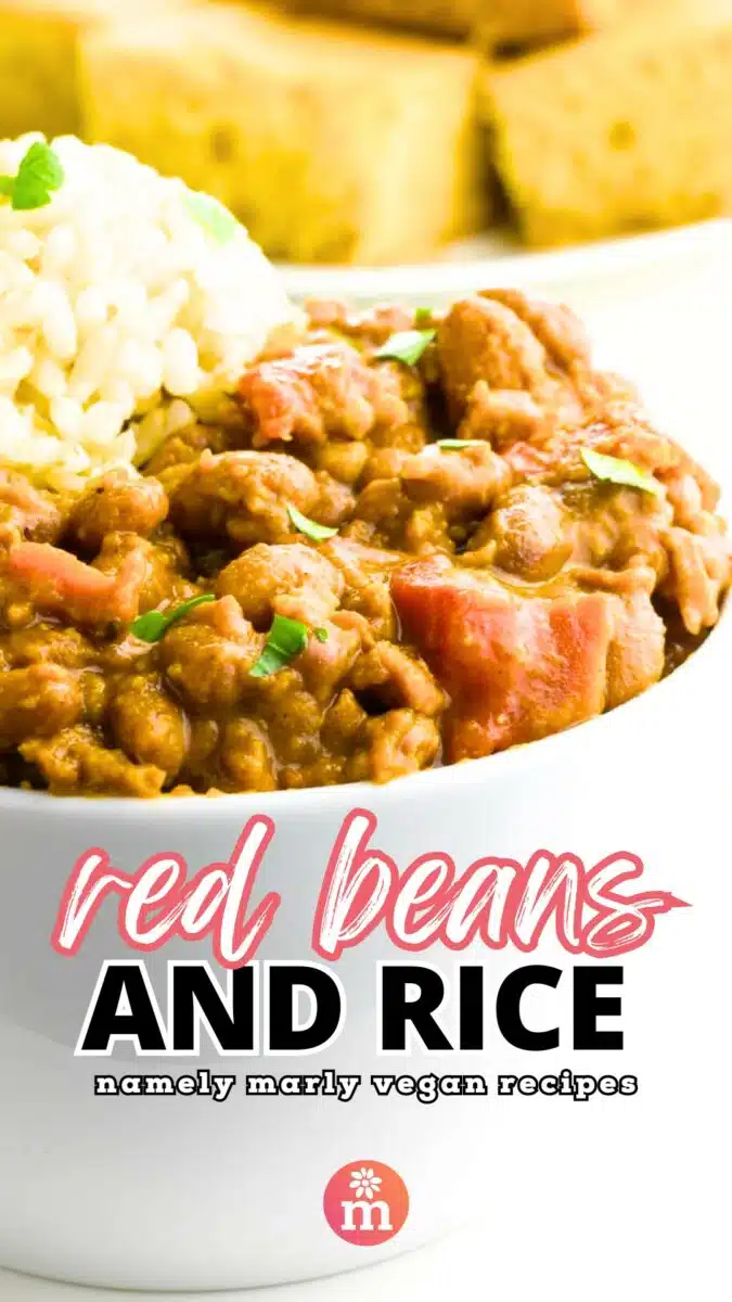 A bowl of beans and rice sits in front of a plate of cornbread. The text reads, Red Beans and Rice, Namely Marly Vegan Recipes.