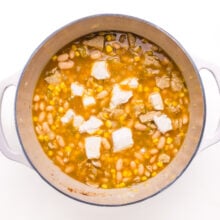 Cream cheese has been added to a pot of white bean chili.