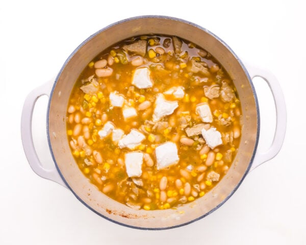 Cream cheese has been added to a pot of white bean chili.