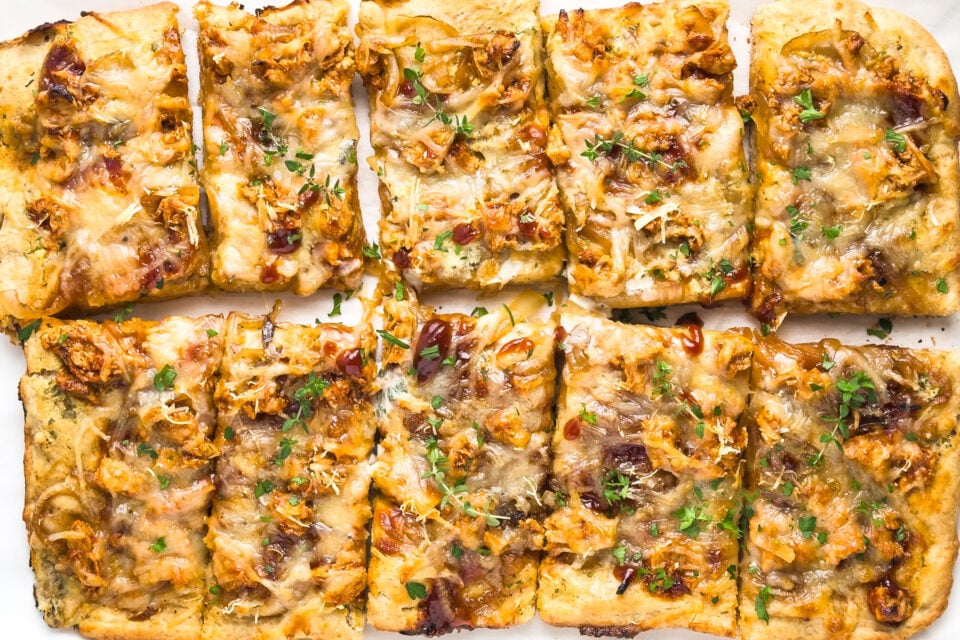 Looking down on a BBQ sheet pan pizza cut into slices.
