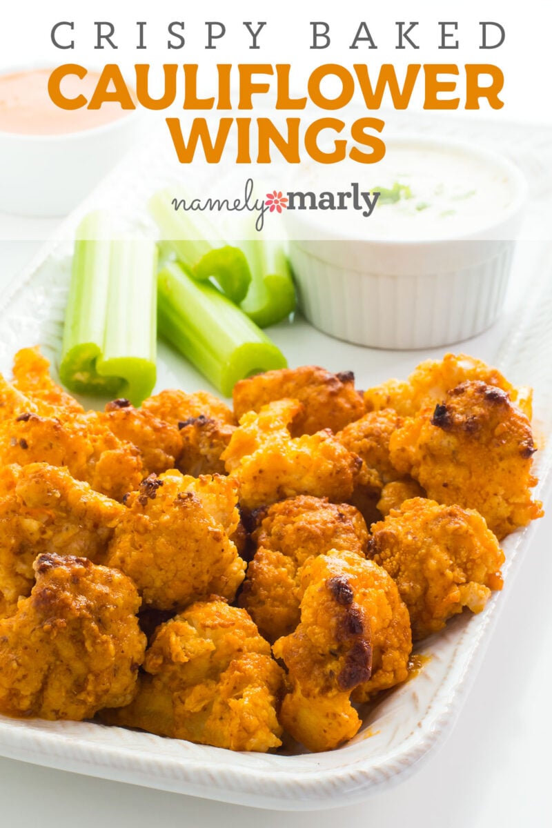 A platter full of cauliflower wings sits on a platter along with celery and a bowl of ranch dip with text that reads Crispy Baked Cauliflower Wings