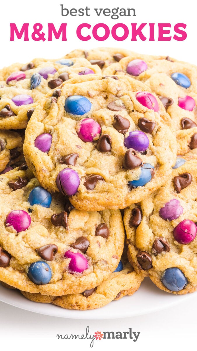 Best Vegan M&M Cookies with image of a plate full of cookies containing brightly-colored m and m pieces and chocolate chips.