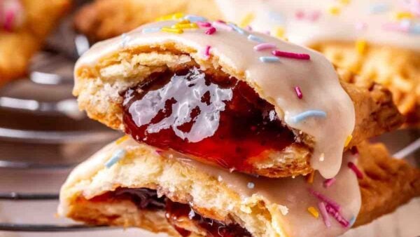 Protein Pop Tarts are stacked on top of each other, revealing lots of jam in the center.