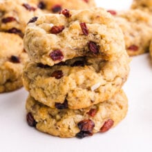 A stack of oatmeal krispie cookies shows the top one with a bite taken out.