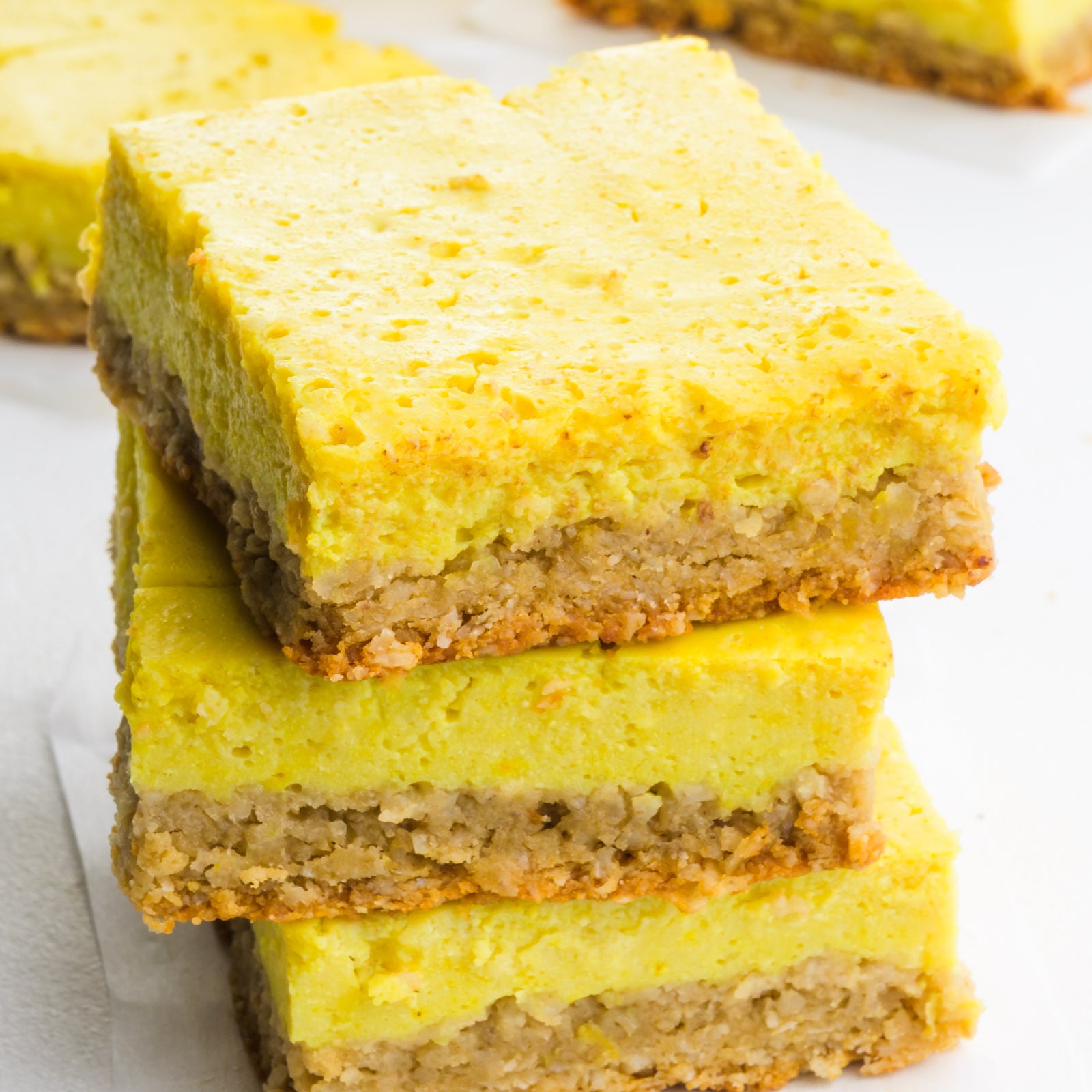 A stack of healthy lemon bars on a white table.