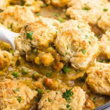 A serving of chickpea pot pie on a spatula hovers over the rest of the dish.