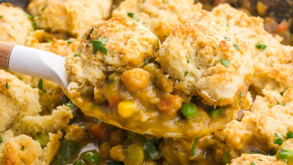 A serving of biscuit-topped chickpea pot pie on a spatula.