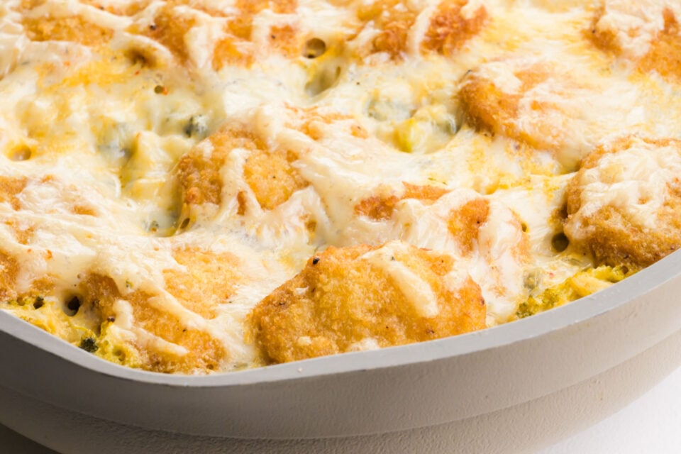 A closeup of vegan chicken broccoli rice casserole in a skillet.