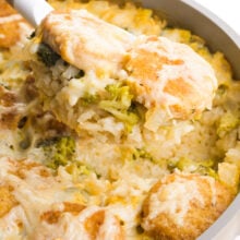 A serving of vegan chicken broccoli and rice casserole is being dished from a skillet.